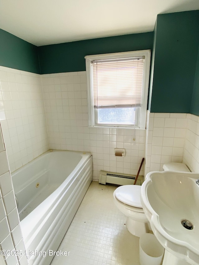 bathroom featuring toilet, tile walls, baseboard heating, tile patterned flooring, and a washtub