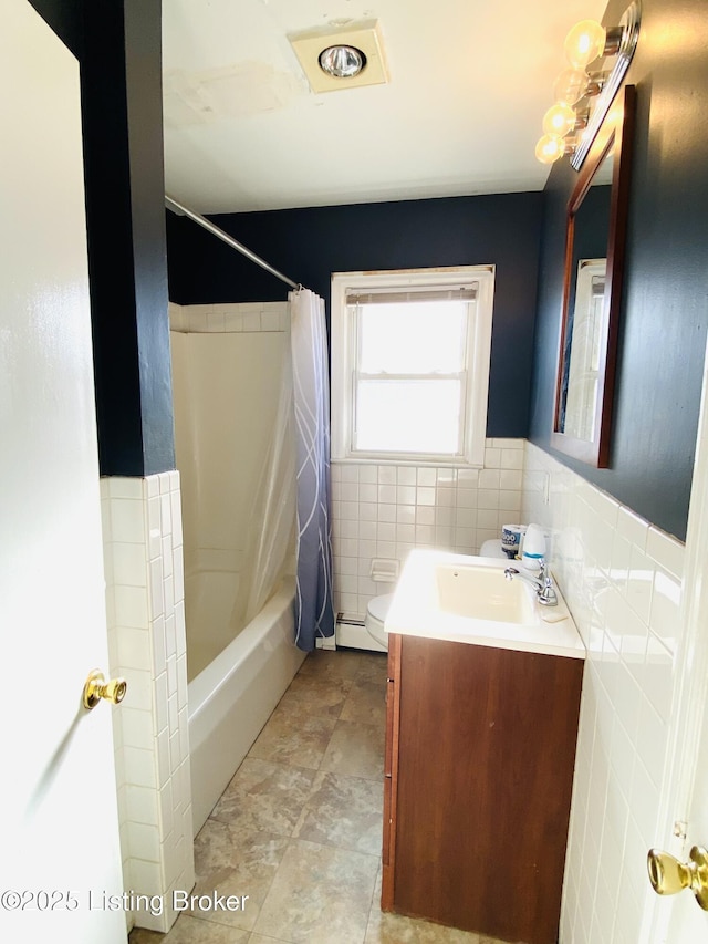 bathroom with vanity, shower / bath combo, tile walls, and a baseboard heating unit