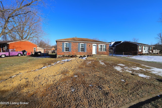 view of front of property with a front lawn and a carport