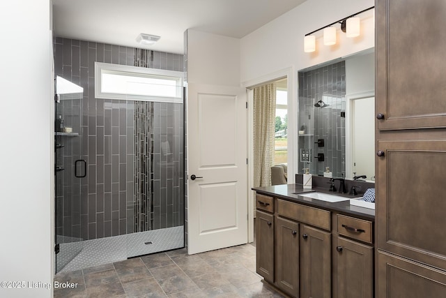 bathroom featuring vanity and an enclosed shower