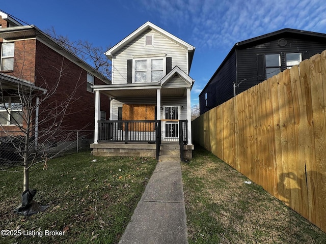 view of front of property featuring a front yard and a porch