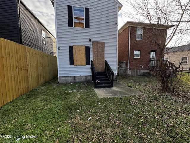 rear view of property with a yard