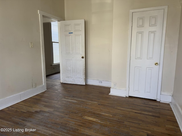 unfurnished room featuring dark wood-type flooring