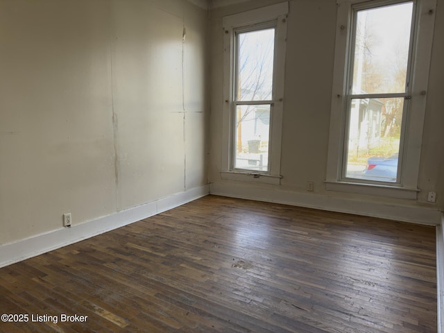 spare room with dark hardwood / wood-style floors