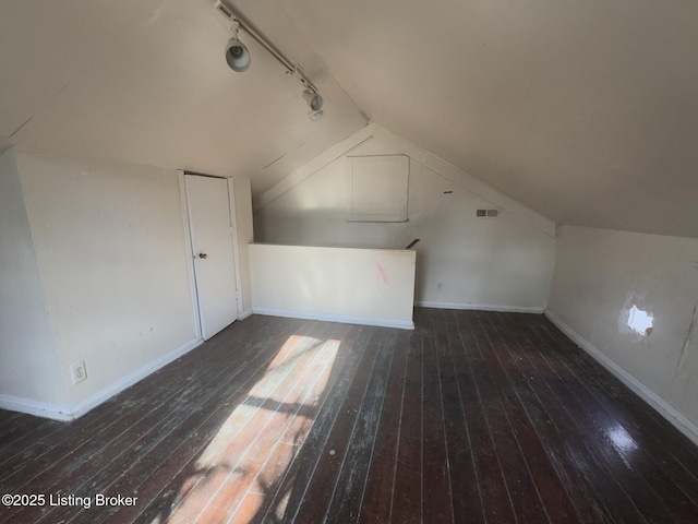 bonus room featuring vaulted ceiling and dark hardwood / wood-style floors