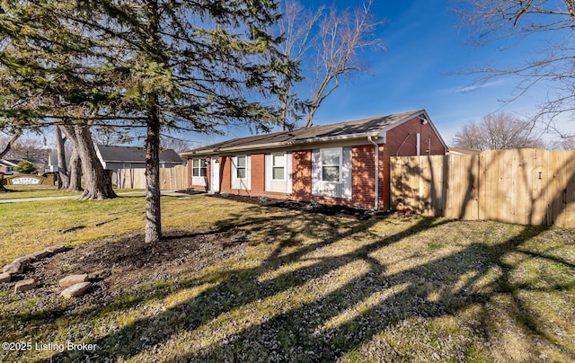 view of side of home featuring a yard