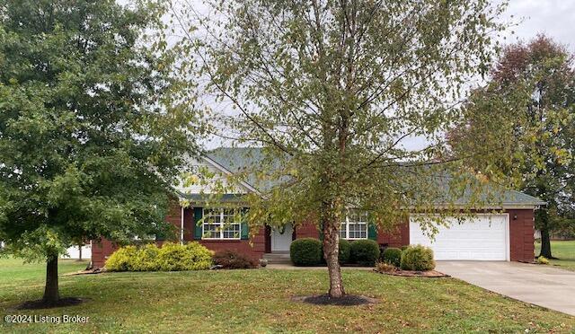 view of front of house with a garage and a front yard