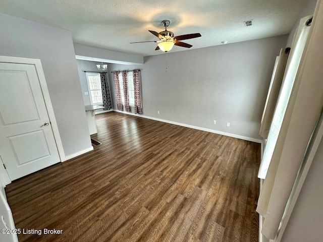 spare room featuring a textured ceiling, dark hardwood / wood-style floors, and ceiling fan