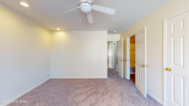 spare room with light carpet and ceiling fan