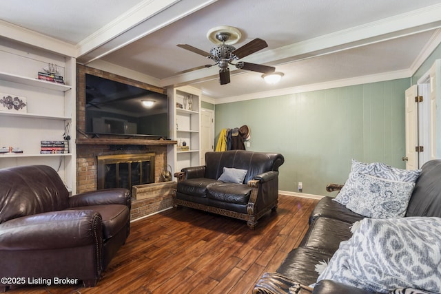 living room with a fireplace, built in shelves, crown molding, and dark wood-type flooring