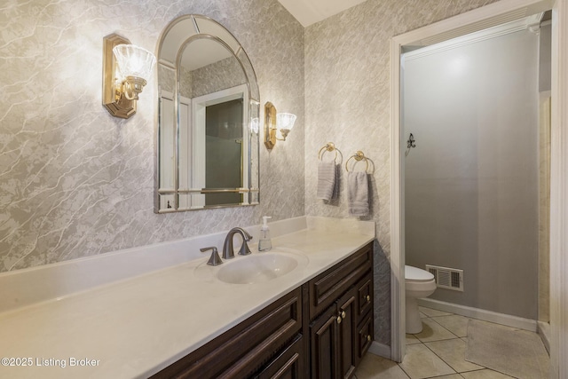 bathroom featuring toilet, vanity, and tile patterned floors