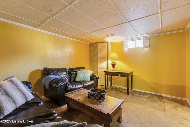 carpeted living room with a paneled ceiling