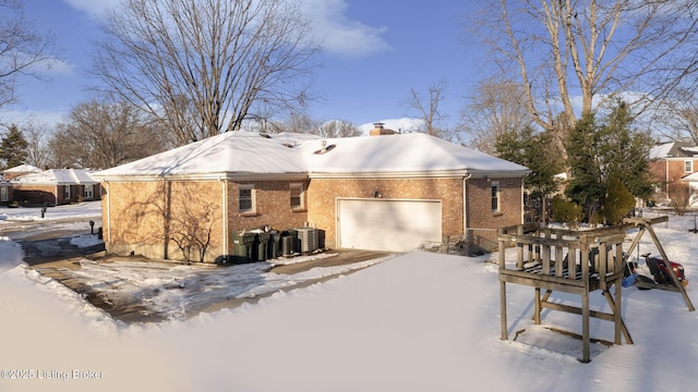 view of front of house featuring cooling unit and a garage