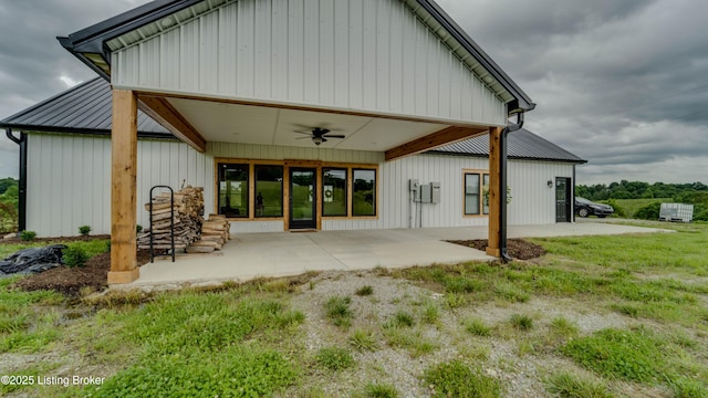 back of property with ceiling fan, a patio, and a yard