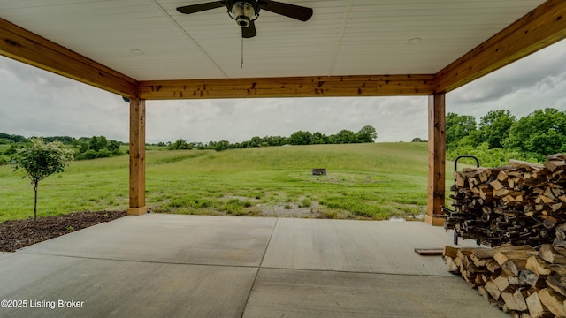 view of patio featuring ceiling fan and a rural view