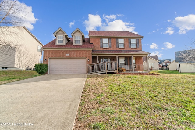 view of front of home with a garage, covered porch, and a front yard