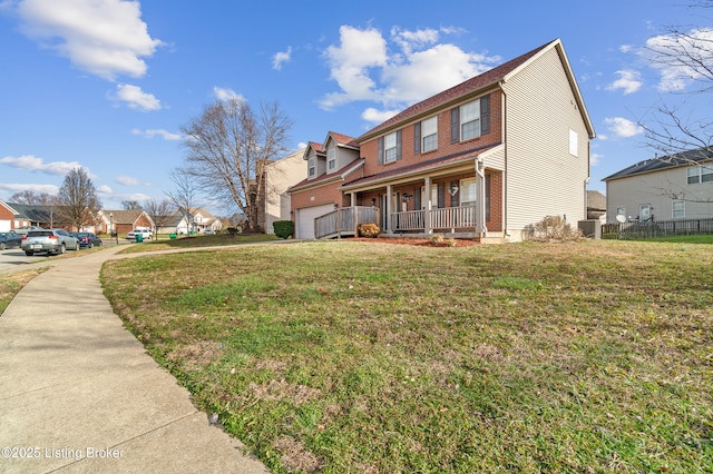 view of side of property with a porch, a garage, cooling unit, and a lawn