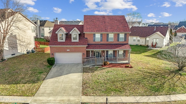 view of front of property with a garage, covered porch, and a front yard