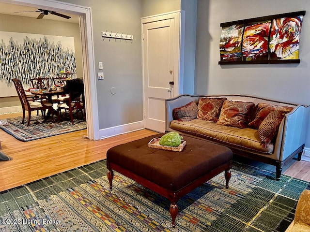 living room with hardwood / wood-style flooring and ceiling fan