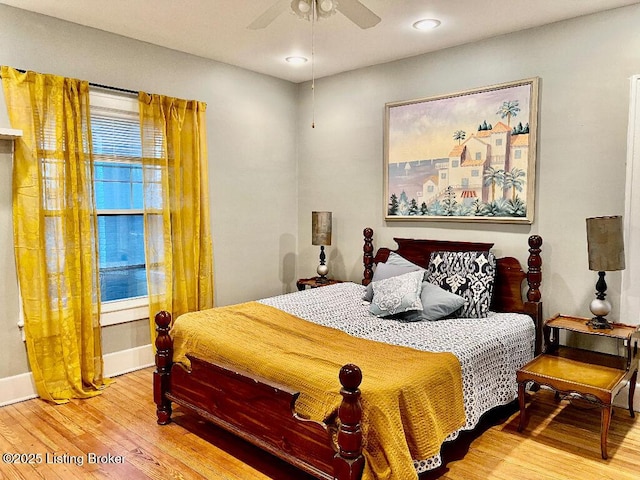 bedroom with hardwood / wood-style floors and ceiling fan