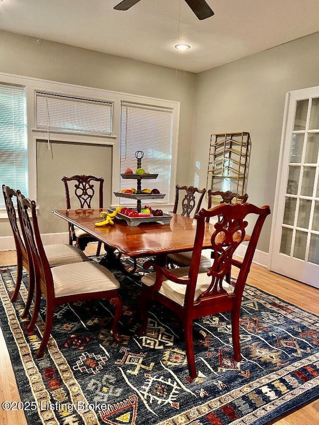 dining space with hardwood / wood-style flooring and ceiling fan