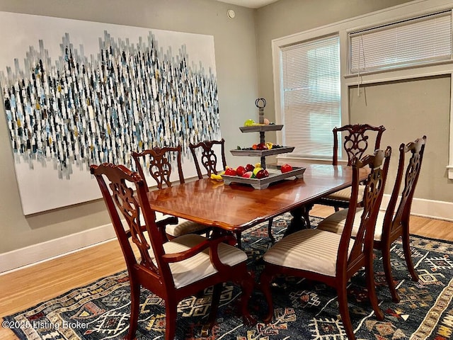 dining space with hardwood / wood-style floors