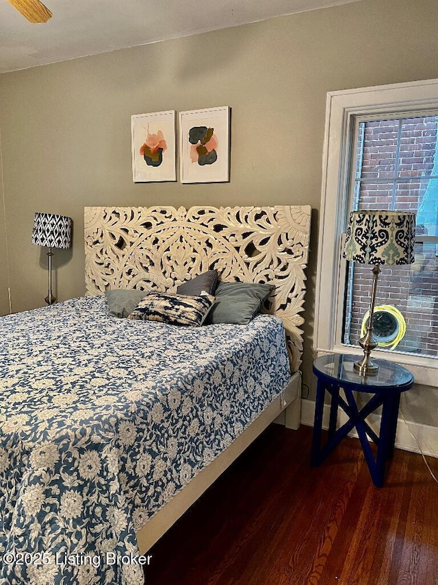 bedroom with dark hardwood / wood-style floors and ceiling fan