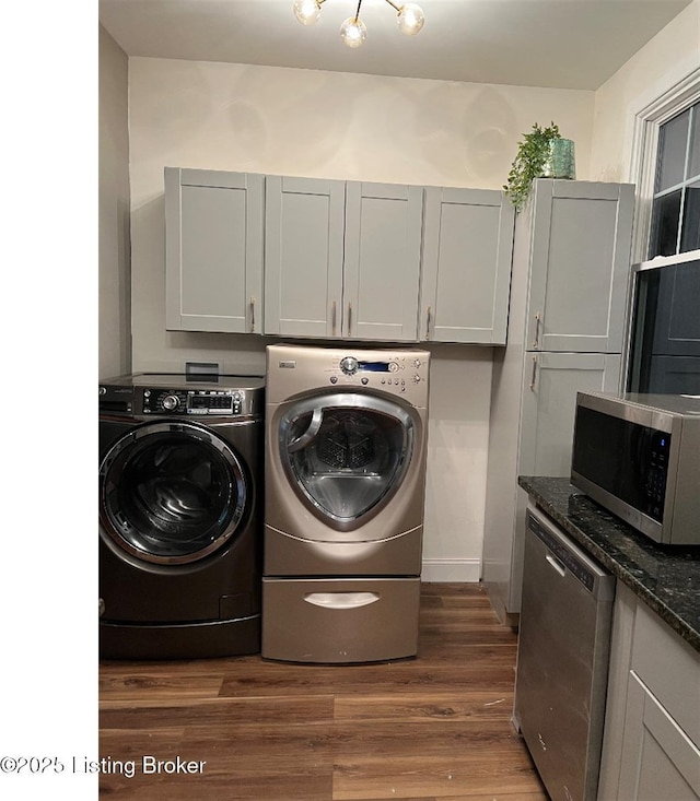 washroom with washing machine and dryer and dark wood-type flooring