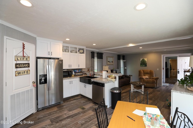 kitchen featuring white cabinetry, sink, appliances with stainless steel finishes, and dark wood-type flooring