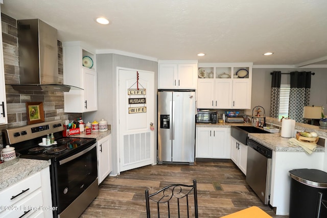 kitchen featuring white cabinets, wall chimney exhaust hood, and stainless steel appliances