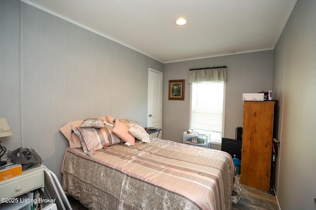 bedroom featuring hardwood / wood-style floors and ornamental molding