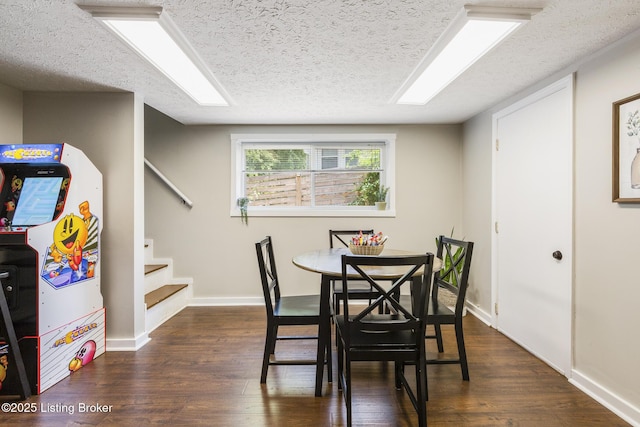 dining area featuring a textured ceiling and dark hardwood / wood-style flooring