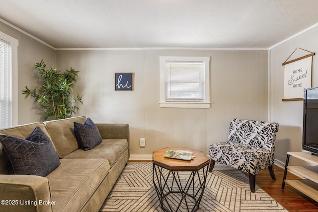 living room with hardwood / wood-style floors and crown molding