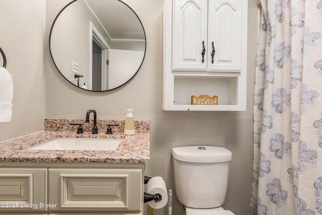 bathroom featuring vanity and toilet