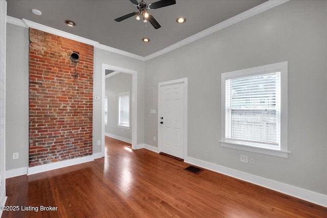 spare room with ceiling fan, wood-type flooring, and crown molding