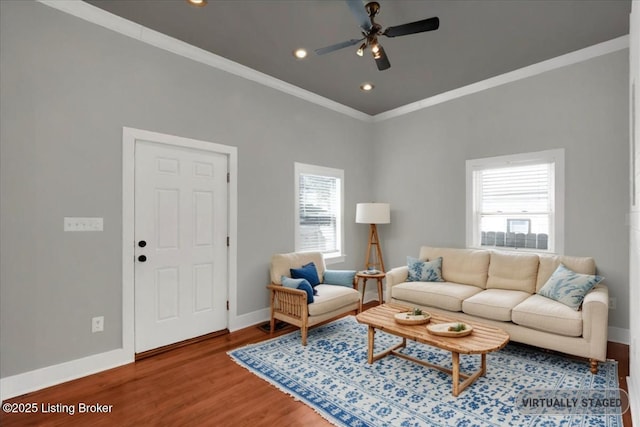 living room featuring wood-type flooring, ceiling fan, and crown molding