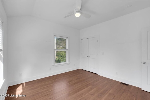 spare room featuring ceiling fan and dark wood-type flooring