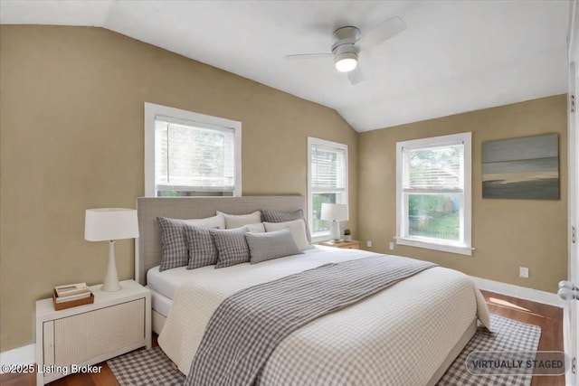 bedroom featuring wood-type flooring, vaulted ceiling, and ceiling fan