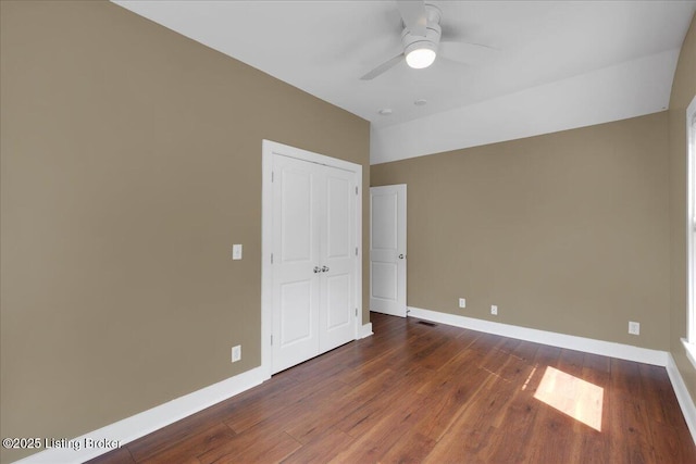 interior space featuring ceiling fan, dark hardwood / wood-style flooring, and lofted ceiling