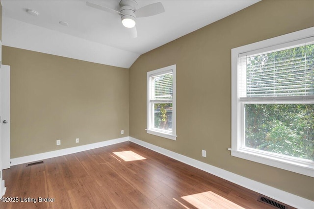 spare room featuring hardwood / wood-style flooring, ceiling fan, and lofted ceiling