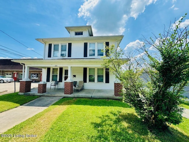 view of front of home featuring cooling unit, covered porch, and a front lawn