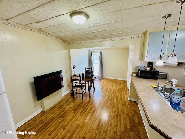 dining area with hardwood / wood-style floors and sink