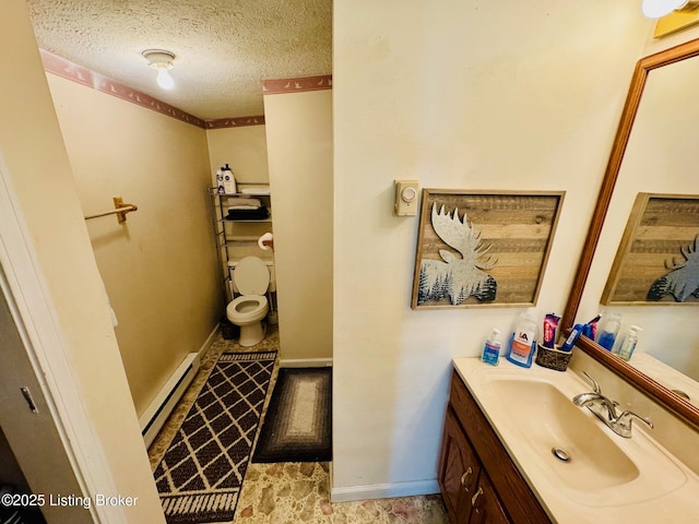 bathroom with vanity, a textured ceiling, toilet, and baseboard heating