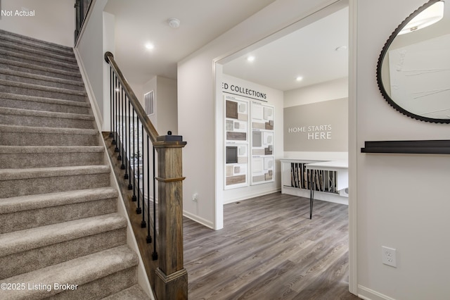 stairway with hardwood / wood-style flooring