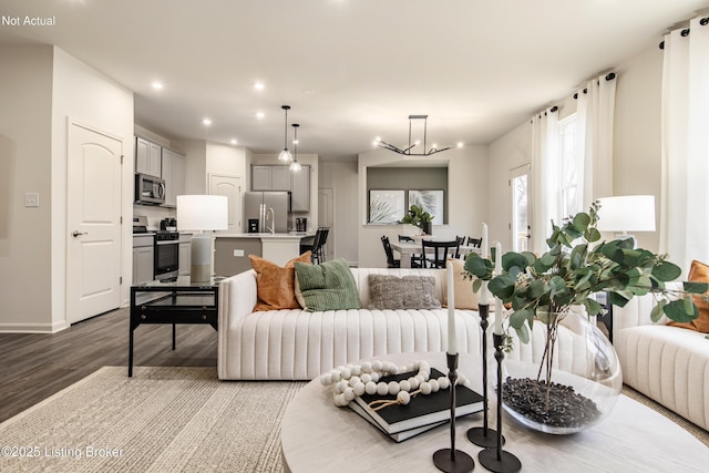 living room featuring an inviting chandelier and light hardwood / wood-style flooring