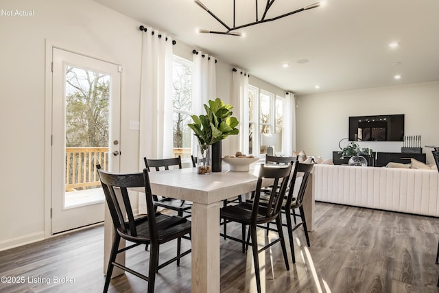 dining room featuring hardwood / wood-style flooring and a chandelier