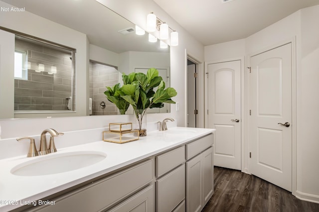 bathroom featuring a shower, vanity, and hardwood / wood-style flooring