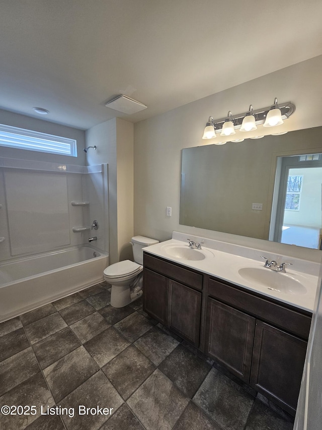 bathroom with  shower combination, double vanity, toilet, and a sink