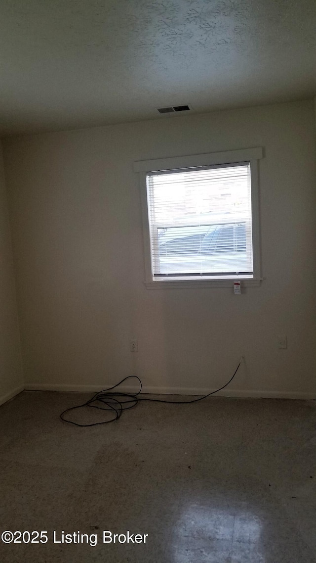 spare room featuring a textured ceiling