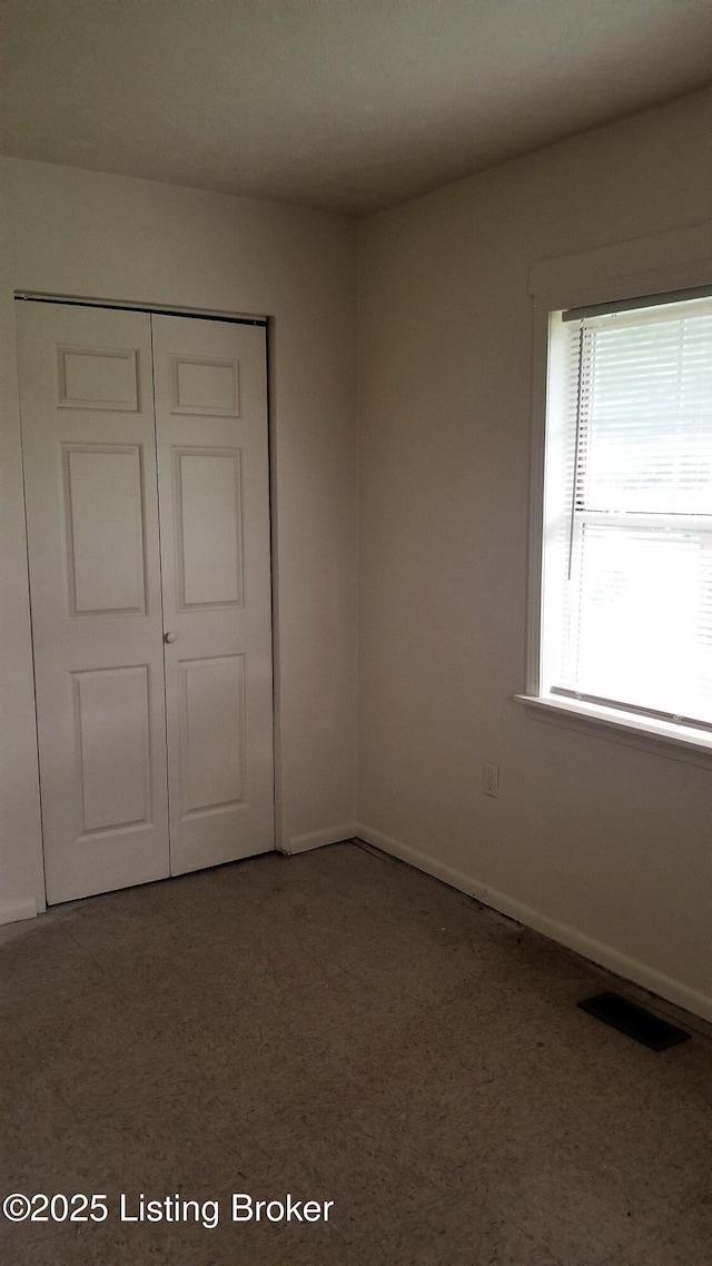 unfurnished bedroom with a closet